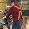Worker wearing orange Lynn Valley Bulldog Suspenders with black bulldog back patch in a woodworking shop